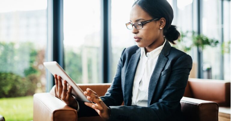 A woman reading from her tablet