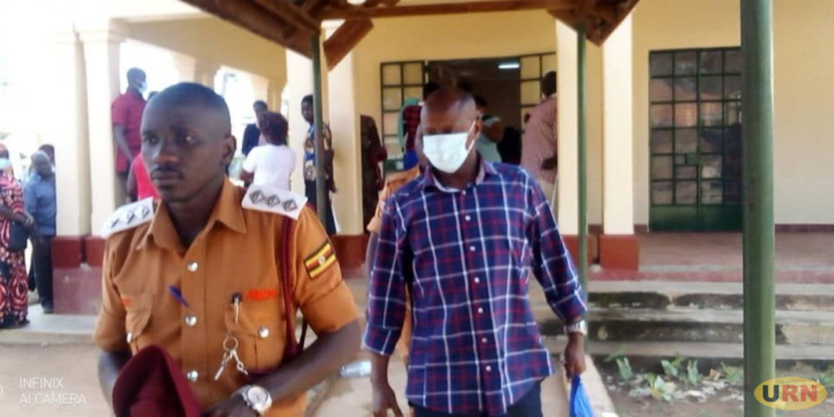 Soroti DISO ( With Mask) being led to Prison / Photo: URN