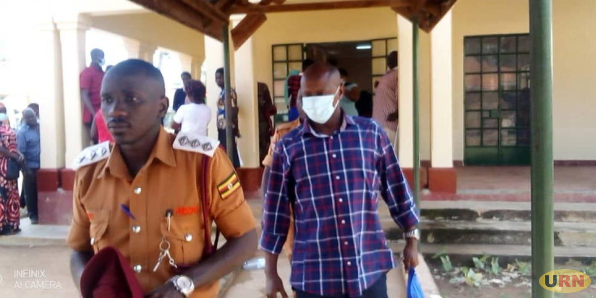 Soroti DISO ( With Mask) being led to Prison / Photo: URN