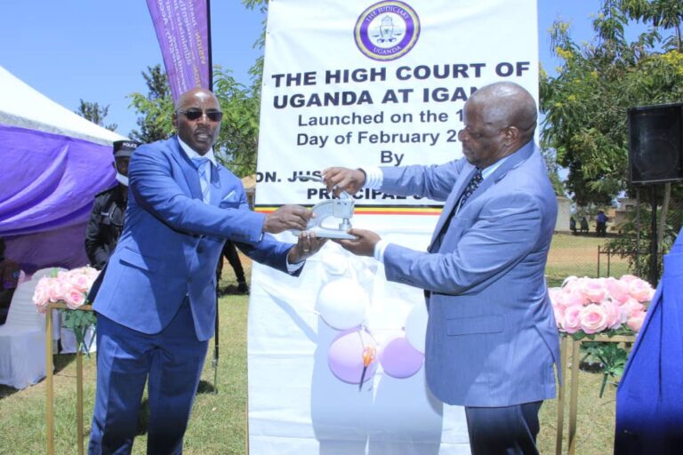 Principal Judge Flavian Zeija Hands Over Court Registers and Court Seal to Justice David Batema./ URN Photo
