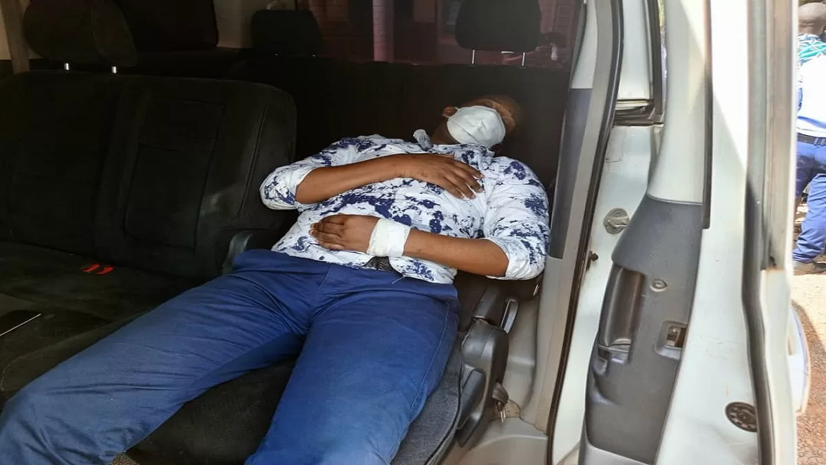 With a cannula on his arm, Allan Ssewanyana remained lying in a vehicle as the court session proceeded./ Photo: Daily Monitor